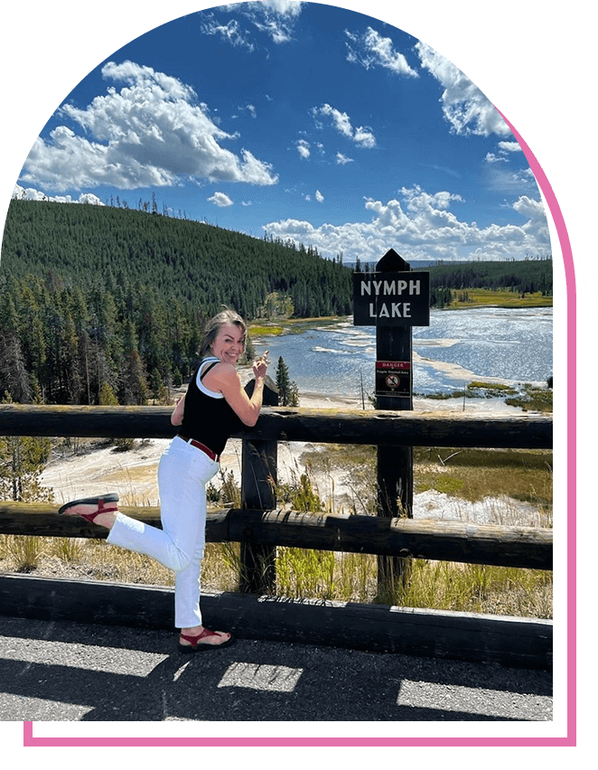 A woman running on the bridge near a lake.