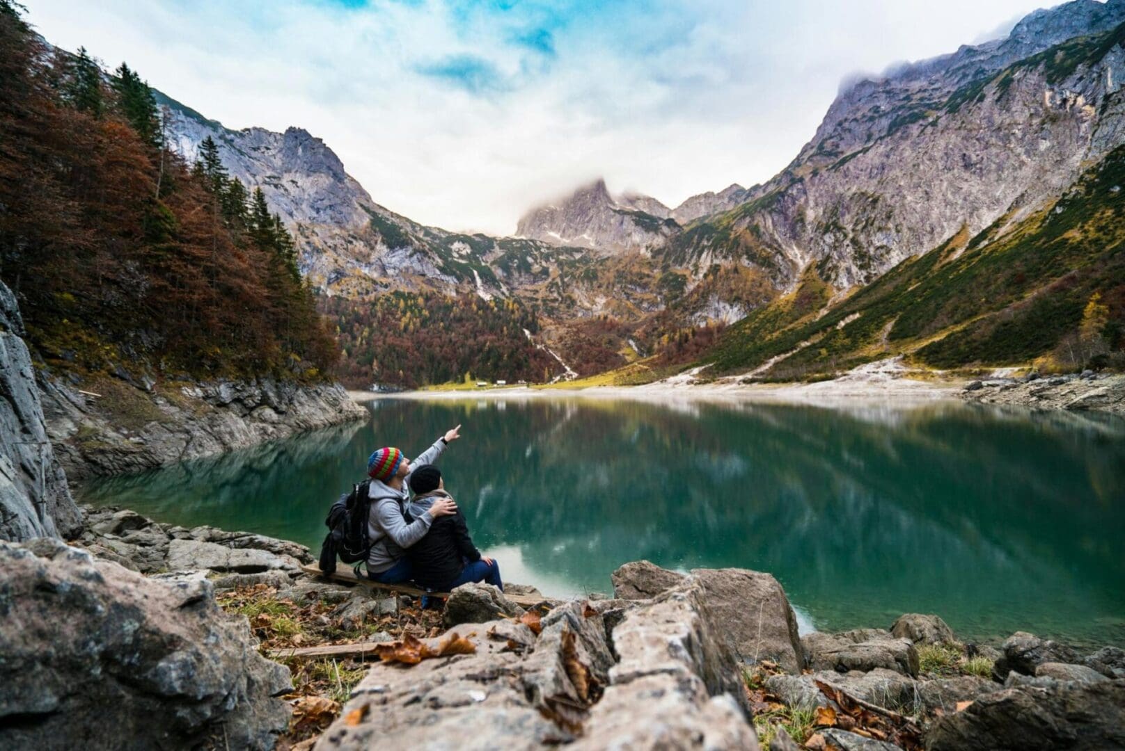 A man sitting on the ground near some water